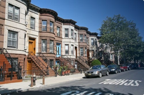 Row of brownstone houses on a sunny day