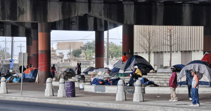 People in a tent encampment under an overpass in New Orleans