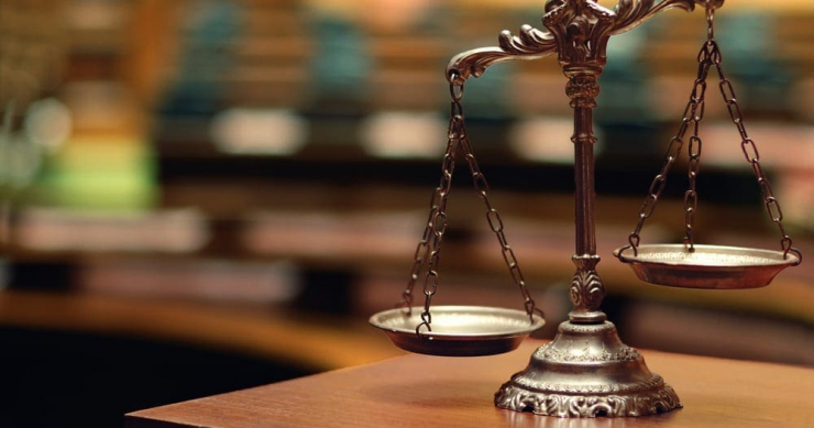 Scales of Justice, with one scale lower than the other