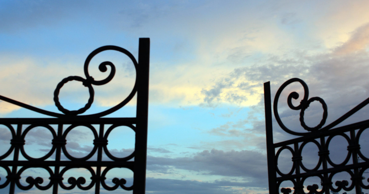Wrought iron gates parting towards the open sky